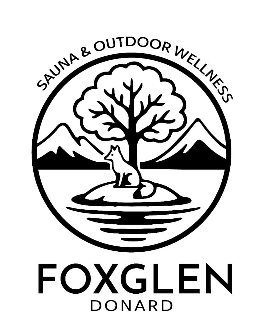 Logo for Foxglen Donard featuring a circle with a fox, tree, mountains, and water, with text surrounding it.